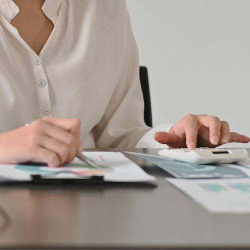 Persona echando cuentas Una mujer hace cuentas con una calculadora
